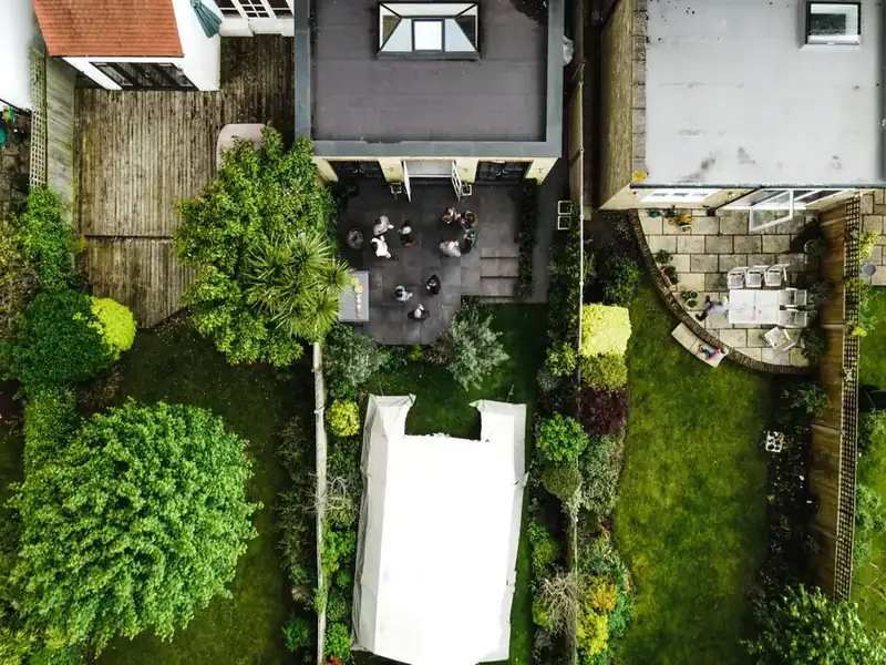 Aerial view of an English family garden showing terrace, lawn and planted beds arranged in simple shapes