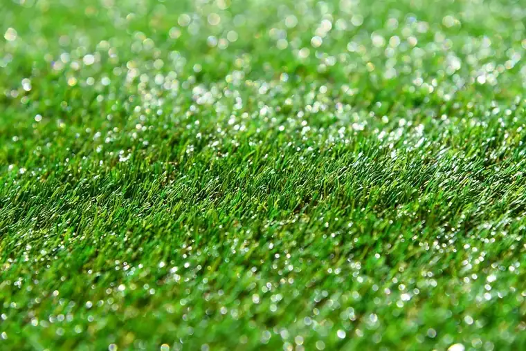Close-up of synthetic grass blades on an artificial lawn in a garden