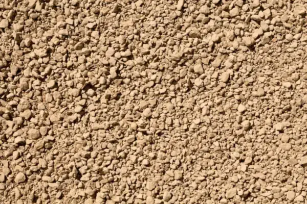 Close view of clean angular gravel, the kind of stone used to backfill a French drain trench in a Hertfordshire garden