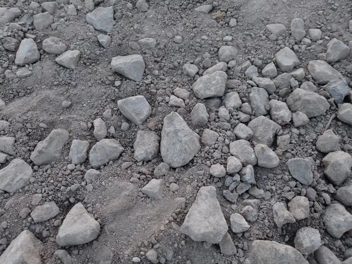 Stony, flint-strewn ground exposed during excavation for a garden building base