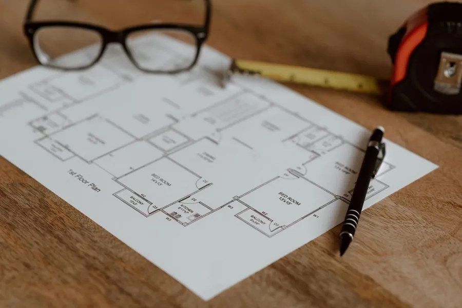 Scaled garden design drawing on a desk with a ruler, pencil and tape measure, the paperwork a design fee pays for