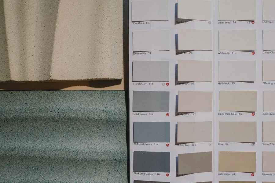 Stone samples beside a British heritage paint colour card, the material palette stage of a St Albans garden design