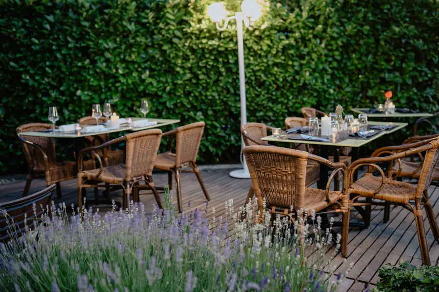 Garden dining tables beside lavender beds on a summer evening