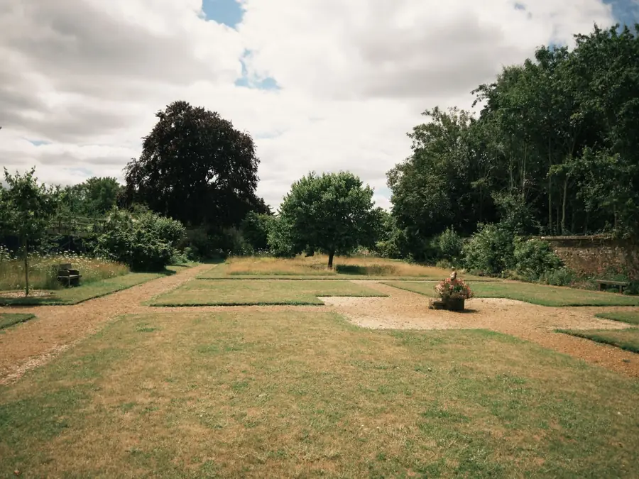 Walled English garden with its layout set out as a grid of paths and beds on the ground, the setting-out information construction drawings provide