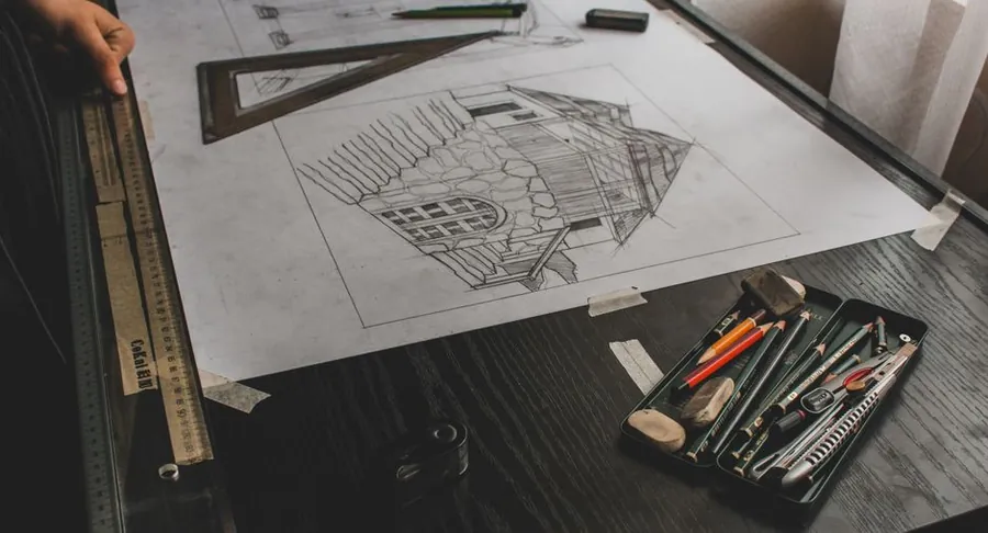 Hand-drawn garden survey sketch on a drawing board with pencils, ruler and set square