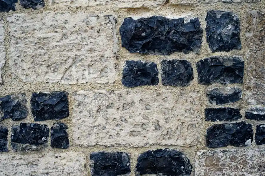 Knapped flint set into pale chalky limestone walling, the flint-in-chalk geology that garden survey test pits keep turning up around St Albans