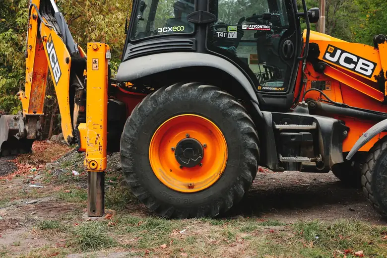 JCB excavator on a Hertfordshire groundworks site, the plant used for level changes and spoil removal in a St Albans garden build