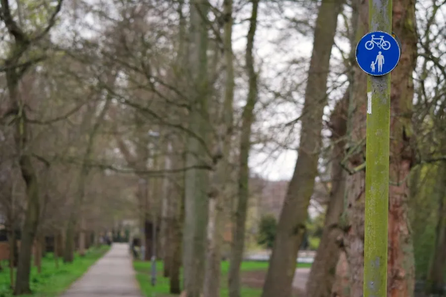Tree-lined shared footpath and cycle path with a blue cycle route sign, like the Nickey Line that runs out of Harpenden towards Hemel Hempstead