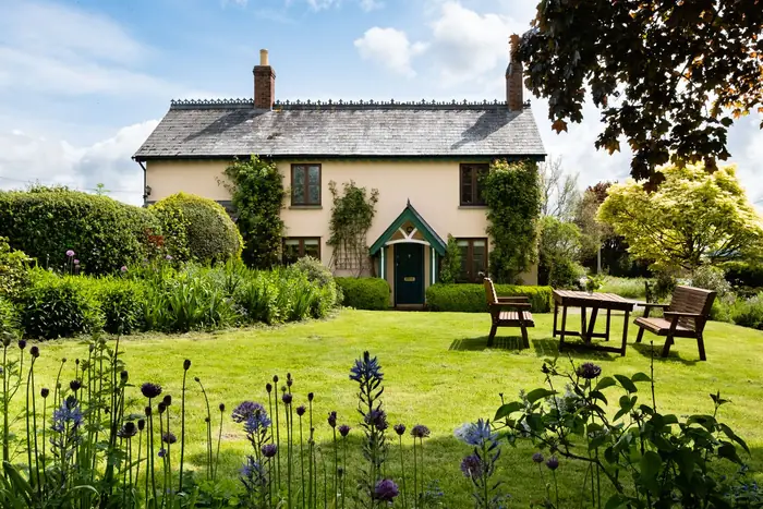 Phased garden with lawn and seating in front of an English house, the end result of a staged St Albans build