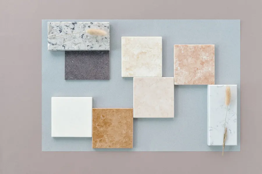 Stone-effect porcelain and natural stone samples laid out side by side, the way a garden designer compares paving finishes for a St Albans terrace