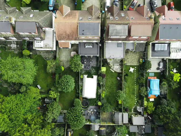 Aerial view of long narrow back gardens behind St Albans houses showing the range of plot sizes a redesign budget has to cover